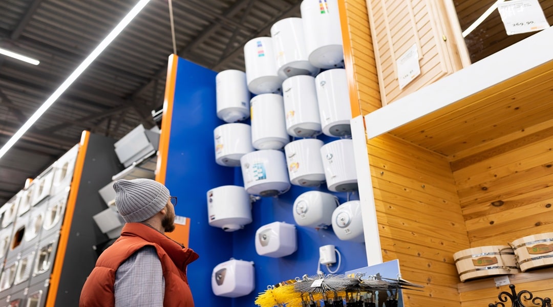 the buyer chooses a boiler for his house in a hardware store